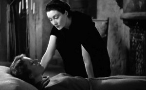 Marya Zaleska se penche sur Lili endormie, scène du film La fille de Dracula.