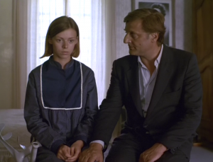 Emmanuelle Debever et Bruno Cremer assis au bord du lit de la chambre de la jeune fille, scène du film Un jeu brutal de Jean-Claude Brisseau.