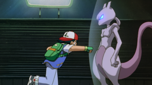 Sacha essaie de donner un coup de poing à Mewtwo qui se protège derrière un bouclier magique, scène du film Pokemon MewTwo contre-attaque.