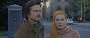 Jean Sorel et Ingrid Thulin regardent intrigués quelque chose à quelques pas, scène dans les rues de Prague issue du film Je suis vivant !