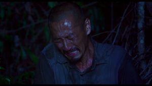 En pleine nuit, Onoda pleure, au coeur de la jungle ; plan rapproché-épaule issu du film de Arthur Harari.