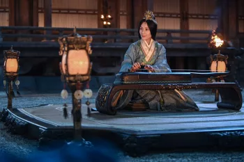 Une princesse, dans une salle éclairée avec de petites lanternes, est à genoux, jouant du guzheng dans le film Creation of the Gods I: Kingdom of Storms.